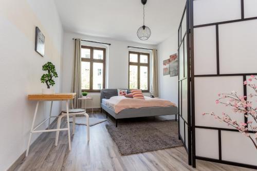 a living room with a couch and a table at FullHouse - Chemnitz - Z25 Apartments - 3 Beds - SmartTV - Nespresso in Chemnitz