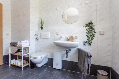 a white bathroom with a sink and a toilet at FullHouse - Chemnitz - Z25 Apartments - 3 Beds - SmartTV - Nespresso in Chemnitz