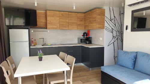 a kitchen and dining room with a table and a couch at Lavanda Mobile Homes & Villas in Orebić