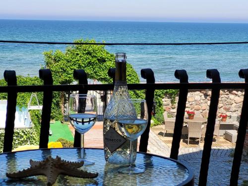 a bottle of wine and a glass on a table at Dom Przy Plaży in Sarbinowo