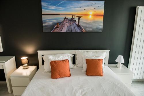 a bedroom with a white bed with orange pillows at Diamond View Apartments in Mamaia