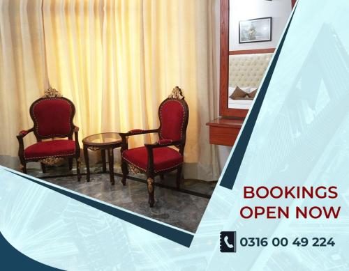 a room with two chairs and a table in a hotel room at Family Guest House Lahore Near Airport in Lahore