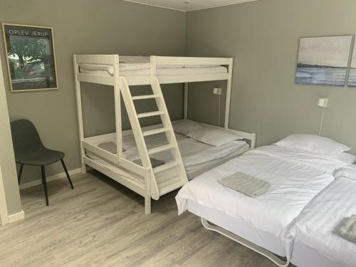 a bedroom with two bunk beds and a ladder at Jerup Bed & Breakfast in Jerup