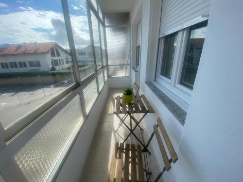 a balcony with a table and two chairs on it at A pie de playa en Suances in Suances