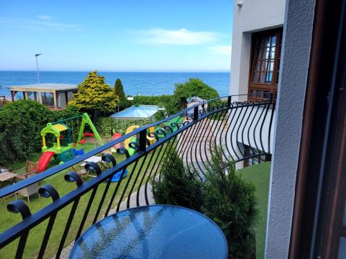 a balcony with a view of a playground at Dom Przy Plaży in Sarbinowo