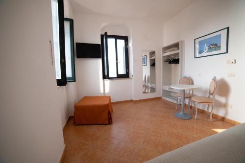 a room with a table and a table and chairs at Hotel Villa A Mare in Rodi Garganico