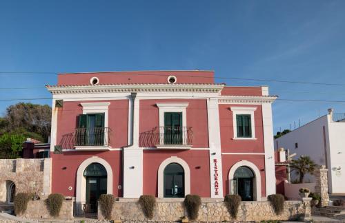 a pink building with two balconies on top of it at Hotel Villa A Mare in Rodi Garganico
