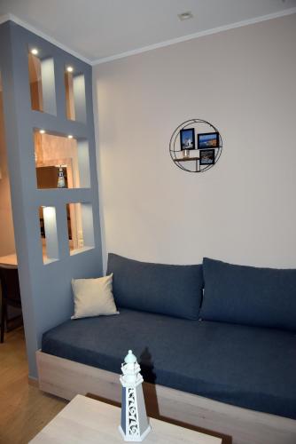 a living room with a blue couch and a table at Shining Star Petra in Petra