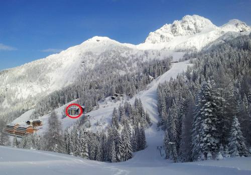 a snow covered mountain with a red sign on it at Apartments Bergblick in Sonnenalpe Nassfeld