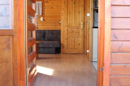 a hallway of a house with wooden doors at Sárberki Horgásztó in Lenti