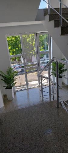 a staircase in a building with windows and a stair case at Stephanovy Guest House in Sozopol