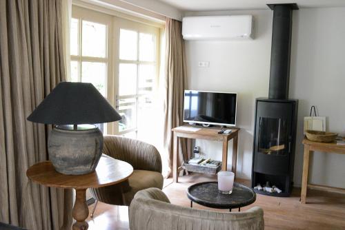 a living room with a living room with a fireplace at bb-jonashome in Venlo