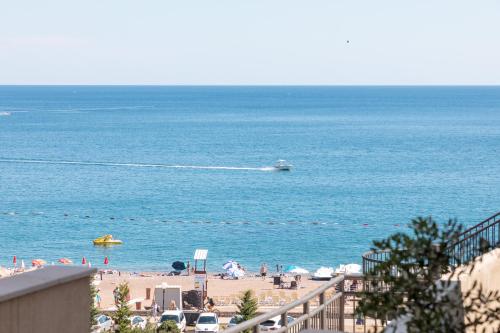 a view of a beach with a boat in the water at Porta Volta Residence in Bečići