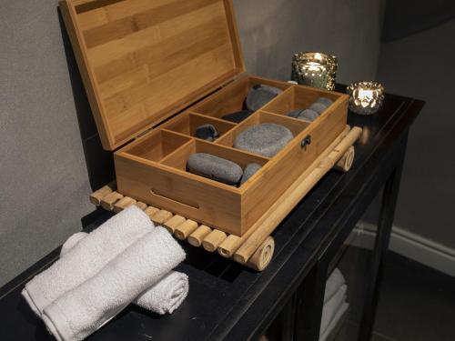 a wooden box sitting on top of a table with towels at Carmella Boutique Hotel in Haifa