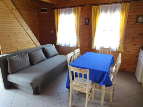 a living room with a couch and a table at Sárberki Horgásztó in Lenti