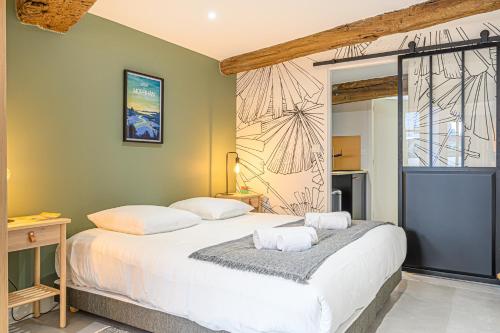 a bedroom with a bed with two pillows on it at LE DREZEN - Cocon tendance au port de Vannes in Vannes