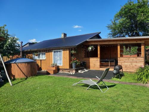 a house with a yard with a chair in front of it at Ziedu aleja in Sigulda