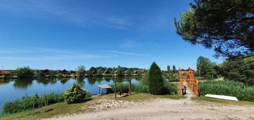 a view of a lake with a wooden structure at Sárberki Horgásztó in Lenti