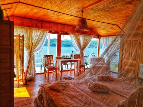 a bedroom with a bed with a view of the ocean at Dream Tricule in Sviniţa