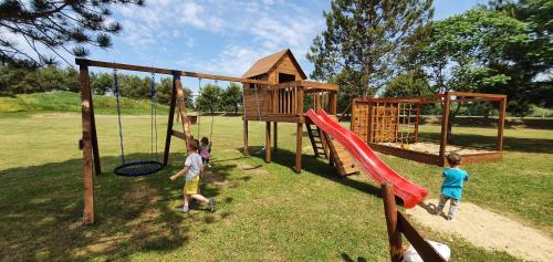 a group of children playing on a playground at Sárberki Horgásztó in Lenti