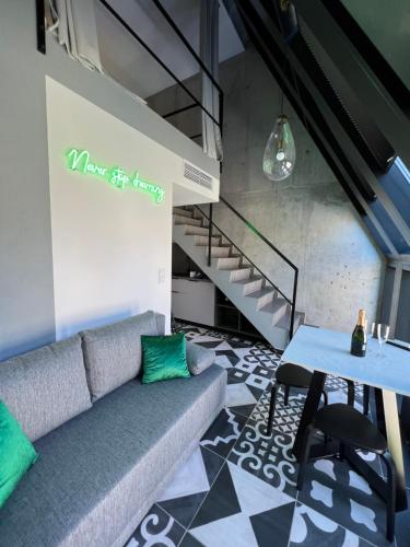 a living room with a couch and a table at NEON APARTMENTS in Sopot