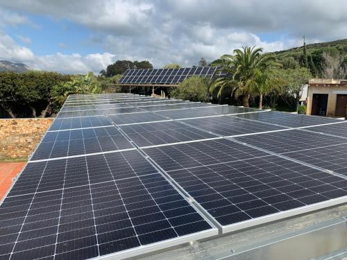 a group of solar panels on top of a roof at Dulce Nombre Hotel - Apartamentos in Tarifa