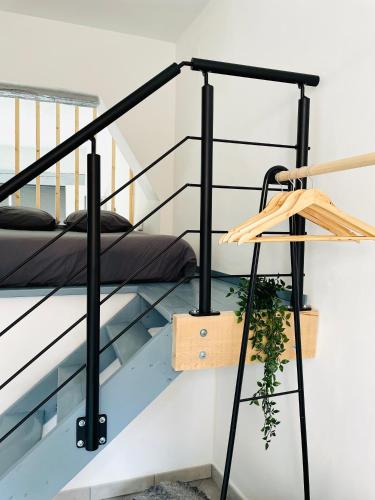 a bed on the stairs of a house at BE MY APPARTS, Studio de charme "LE CARILLON", DOUAI, Coeur de ville in Douai