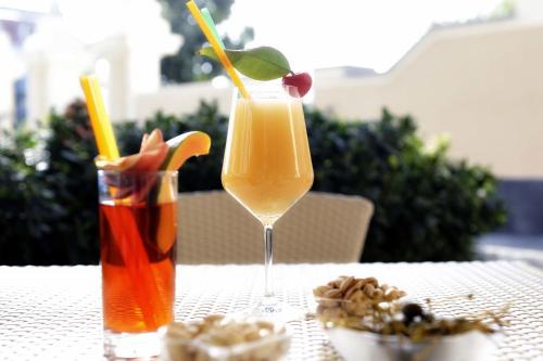 a table with two drinks and a bowl of nuts at Relais Villa Buonanno in Cercola