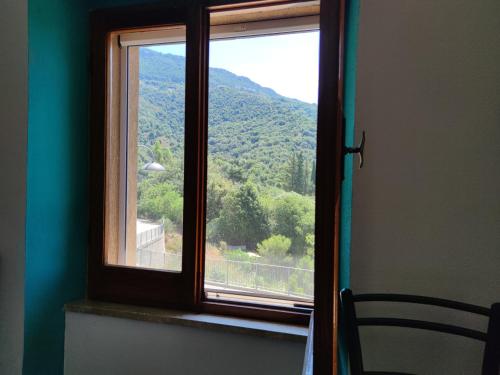 a window in a room with a view of a mountain at Sa Dommu 'e su coro in Triei
