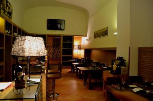 a dining room with tables and chairs in a restaurant at Relais Villa Buonanno in Cercola