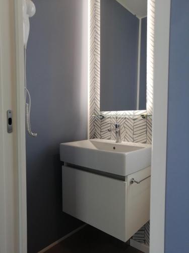 a bathroom with a white sink and a mirror at Camping Village Riva Blu in Padenghe sul Garda