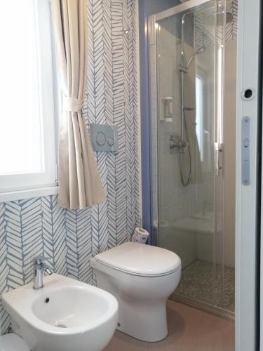 a bathroom with a toilet and a sink and a shower at Camping Village Riva Blu in Padenghe sul Garda