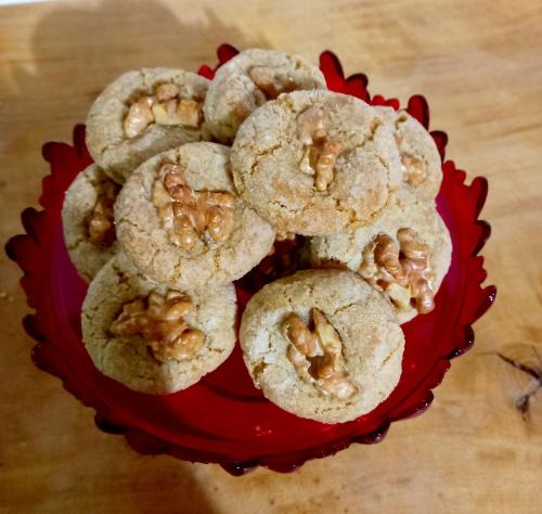 a red bowl of cookies with walnuts on top at B&B Santu Giuvanni "Un tuffo nel passato Fonnese" in Fonni