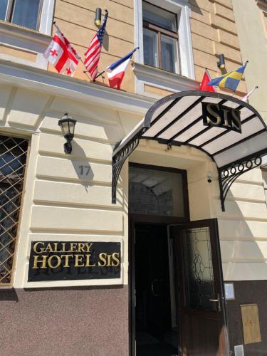 a building with an entrance to a hotel with american flags at Gallery Hotel SIS in Prague