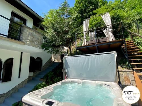 una bañera de hidromasaje en el patio trasero de una casa en ARTtrend Luxury Villa, en Tihany