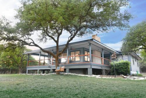 a large house with a tree in front of it at Amazing Modern Farmhouse Retreat w/ 2 Suites in Canyon Lake