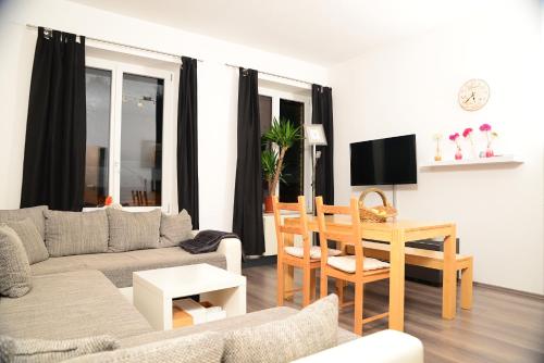 a living room with a couch and a table at Ferienanlage Markus Nitsch in Bärenstein