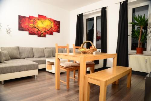 a living room with a table and a couch at Ferienanlage Markus Nitsch in Bärenstein