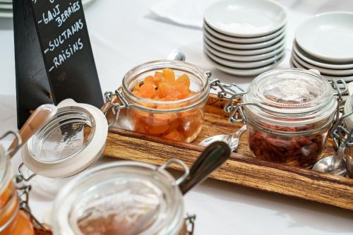 a tray with jars of food on a table at Hotel Dom Goncalo & Spa in Fátima