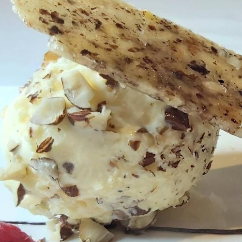 a piece of bread with nuts on it on a plate at No11 Boutique Hotel & Brasserie in Edinburgh
