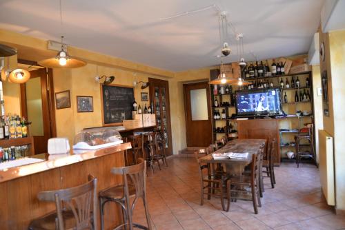 a restaurant with a bar and tables and a tv at Locanda Milano 1873 in Brunate