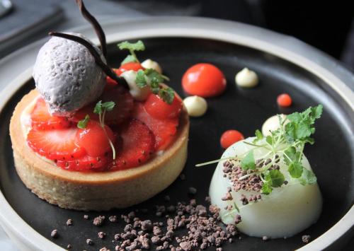 a plate with a dessert with fruit on it at No11 Boutique Hotel & Brasserie in Edinburgh