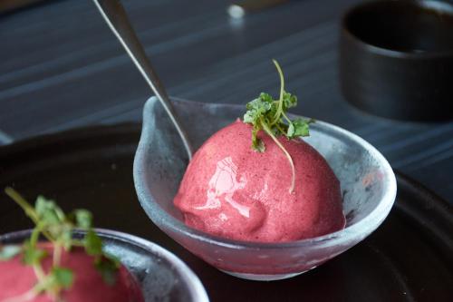 a pink ice cream in a bowl on a table at No11 Boutique Hotel & Brasserie in Edinburgh