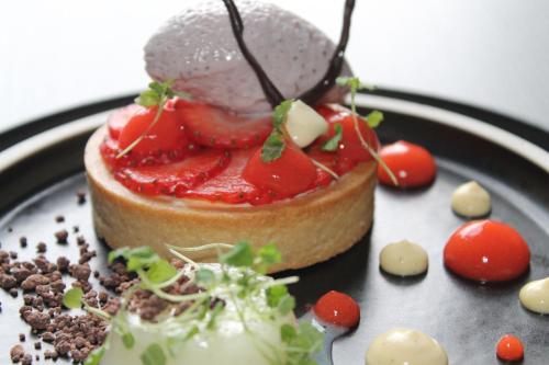 a dessert on a plate with strawberries on it at No11 Boutique Hotel & Brasserie in Edinburgh
