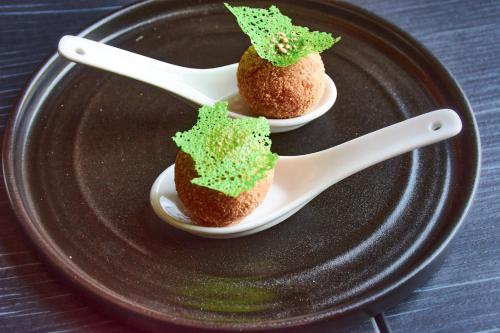 two deserts on a plate with a spoon and a fork at No11 Boutique Hotel & Brasserie in Edinburgh