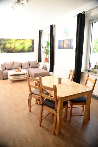 a living room with a wooden table and chairs at Ferienanlage Markus Nitsch in Bärenstein