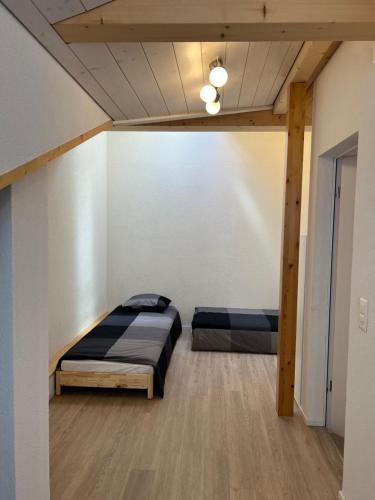 a bedroom with two beds in a room at Esencial Apartment Interlaken in Interlaken