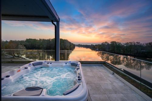 a jacuzzi tub with a view of a river at Mercure Tokaj Center in Tokaj