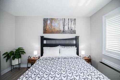 a bedroom with a bed and a painting on the wall at Slopeside Sanctuary - Ski In/Ski Out in Blue Mountains