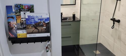 a bathroom with a shower and a glass door at A ESTRENAR PRECIOSOS APARTAMENTOS APARTHOTEL INTER2, NEW APARTMENTS lN APARTHOTEL 12 months open! self check in! RESERVA Garaje! in Salou